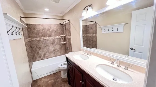 a bathroom with a granite countertop sink a mirror a shower and a bathtub