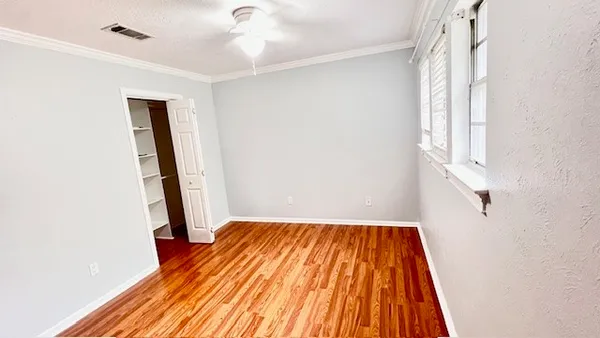 a view of a room with wooden floor and stairs