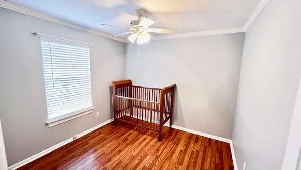 a view of wooden floor and windows in a room