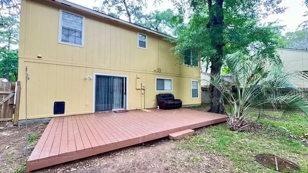 a view of a house with backyard and sitting area