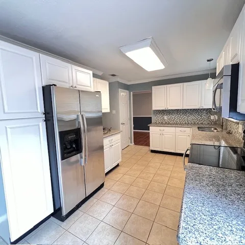 a kitchen with stainless steel appliances a refrigerator sink and microwave