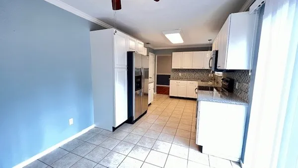 a hallway with a couch and a potted plant