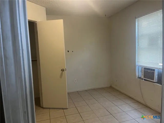 a view of a refrigerator in kitchen and a sink