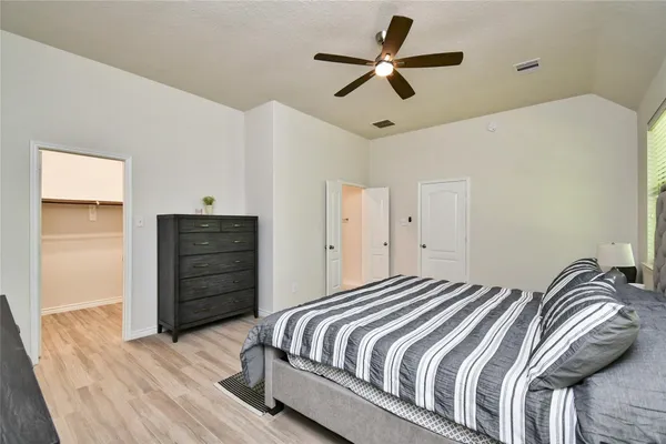 a bedroom with a bed and a chandelier