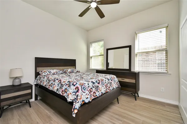 a bedroom with a bed lamp and a window