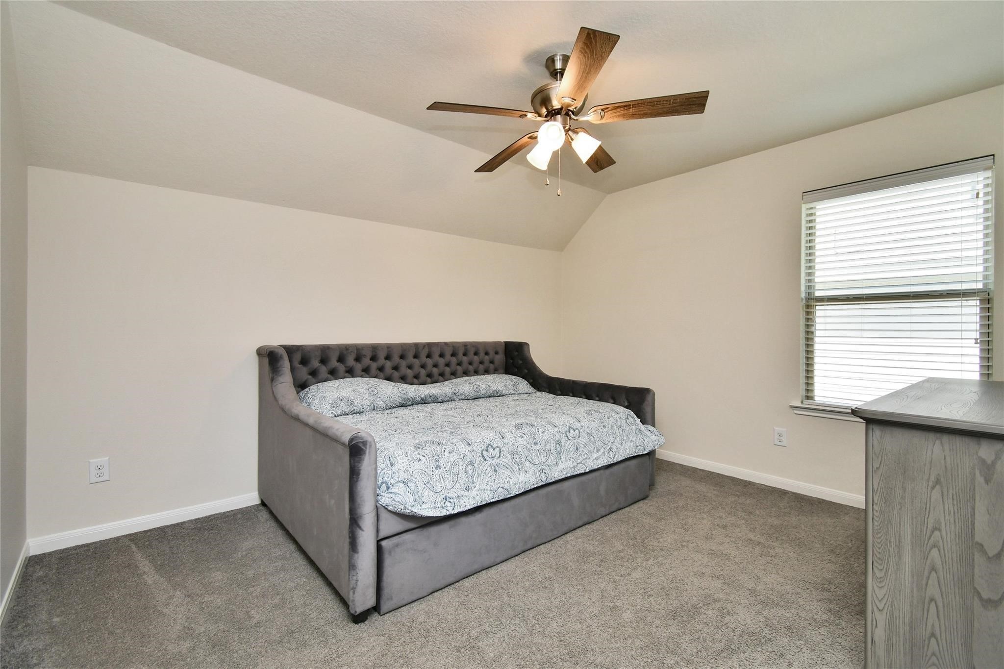 22 Wood Drake Place Tomball, TX 77375 - Photo 17 of 21 a spacious bedroom with a bed and a chandelier
