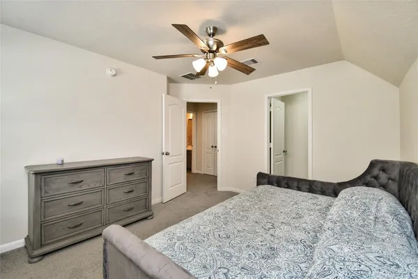 a bedroom with a bed and a dresser