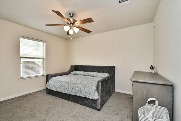 a bedroom with a bed and window