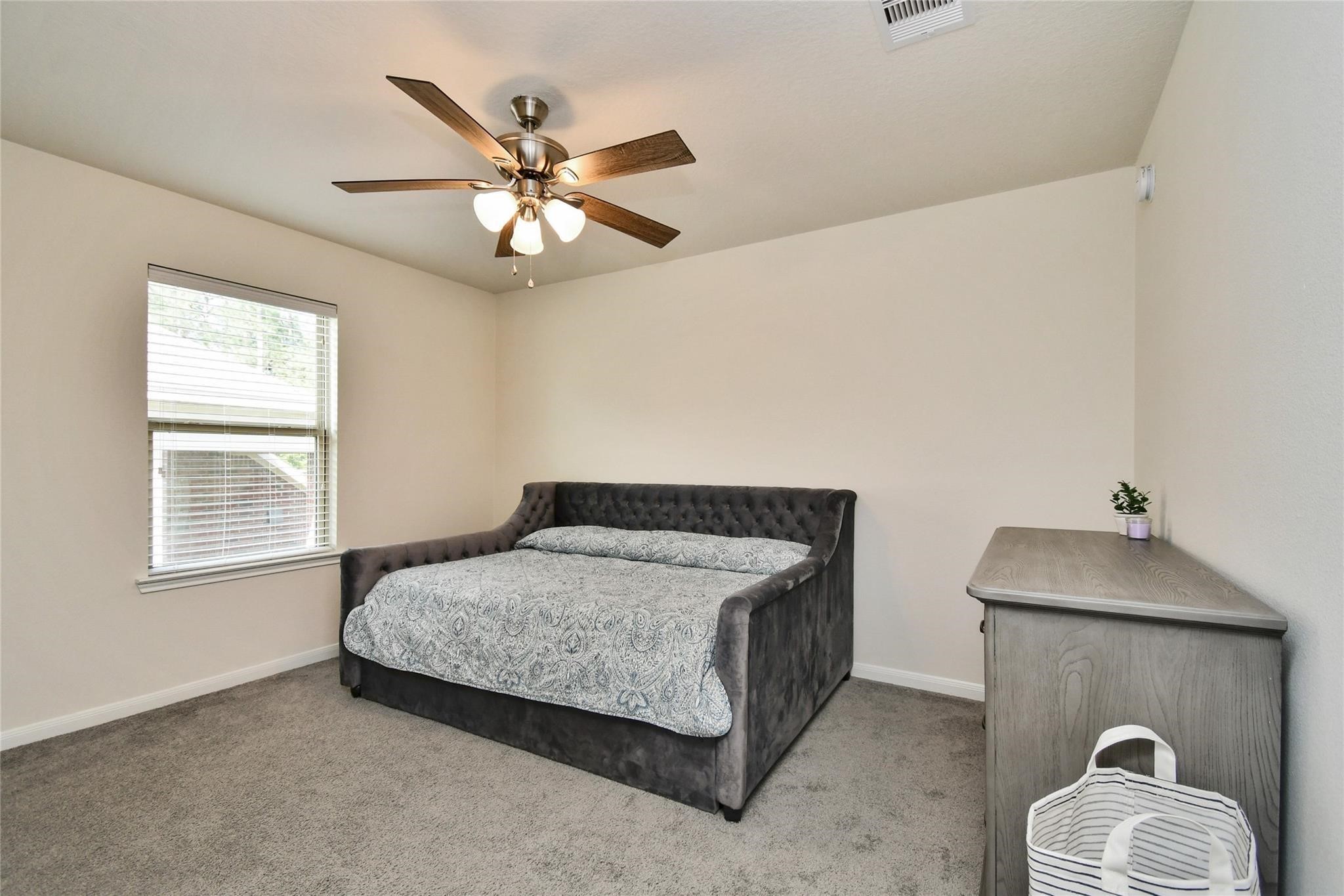 22 Wood Drake Place Tomball, TX 77375 - Photo 20 of 21 a bedroom with a bed and window