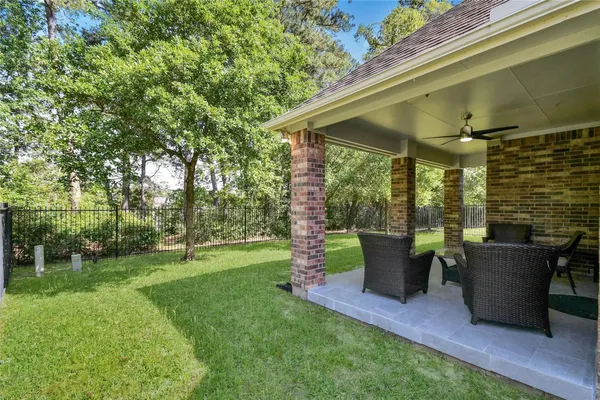 a view of backyard of house with outdoor seating and green space