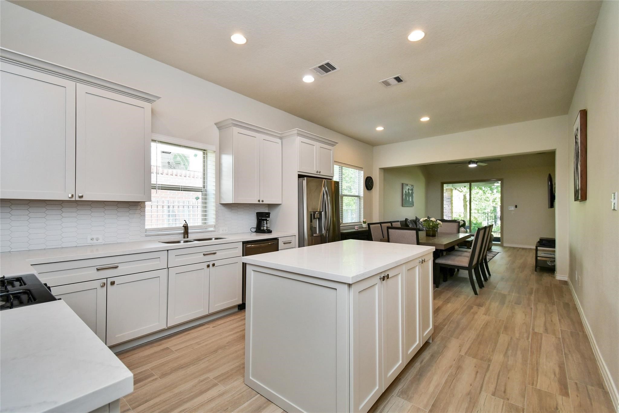 22 Wood Drake Place Tomball, TX 77375 - Photo 4 of 21 a kitchen with a sink a counter top space stainless steel appliances and windows