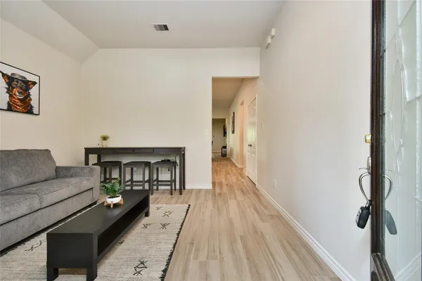 a living room with furniture and a wooden floor