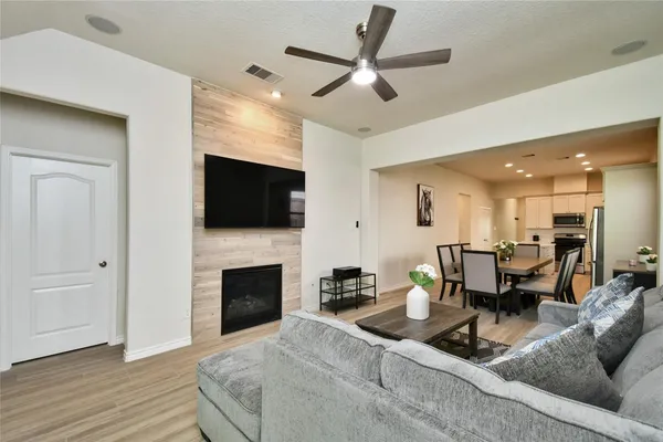 a living room with fireplace furniture and a flat screen tv