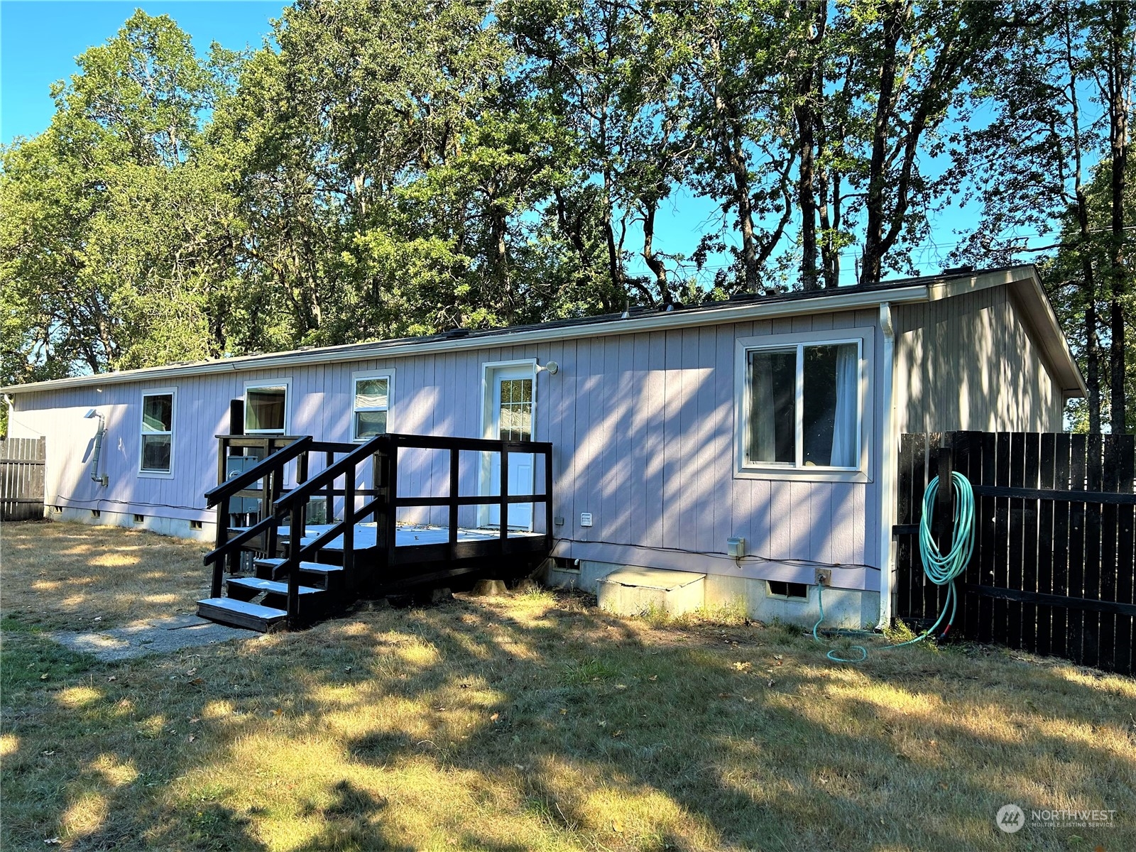 8145 183rd Avenue Southwest Rochester, WA 98579 - Photo 27 of 33 a view of a wooden house with a yard