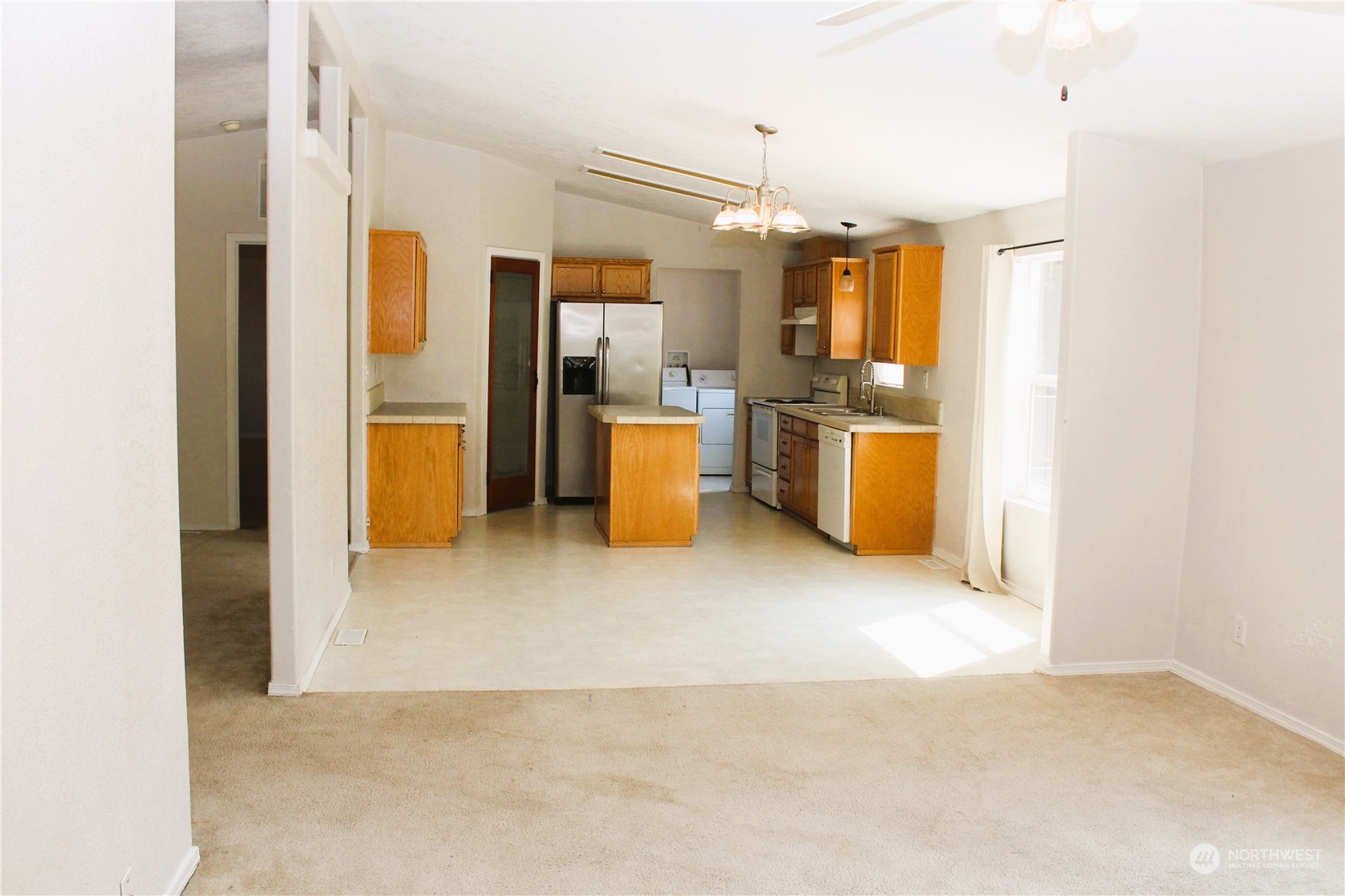 8145 183rd Avenue Southwest Rochester, WA 98579 - Photo 6 of 33 a view of a kitchen with a refrigerator and a sink