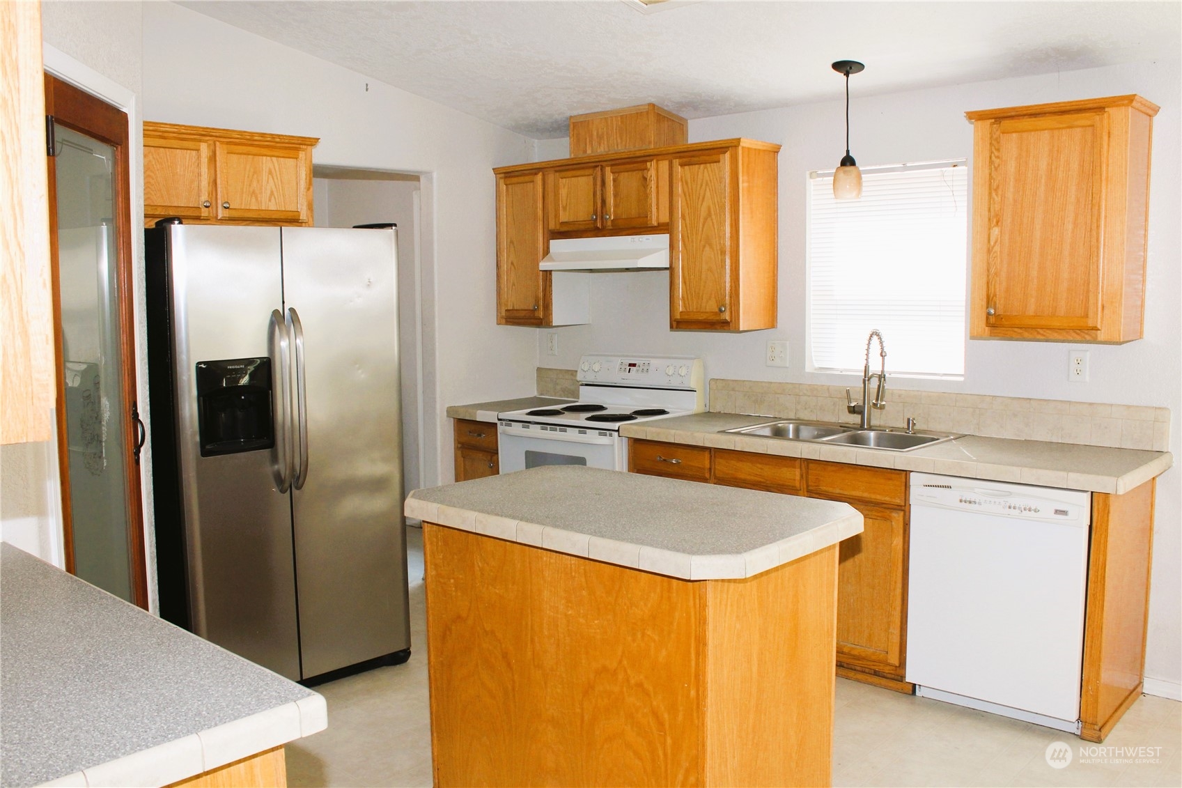 8145 183rd Avenue Southwest Rochester, WA 98579 - Photo 7 of 33 a kitchen with stainless steel appliances a refrigerator and a sink