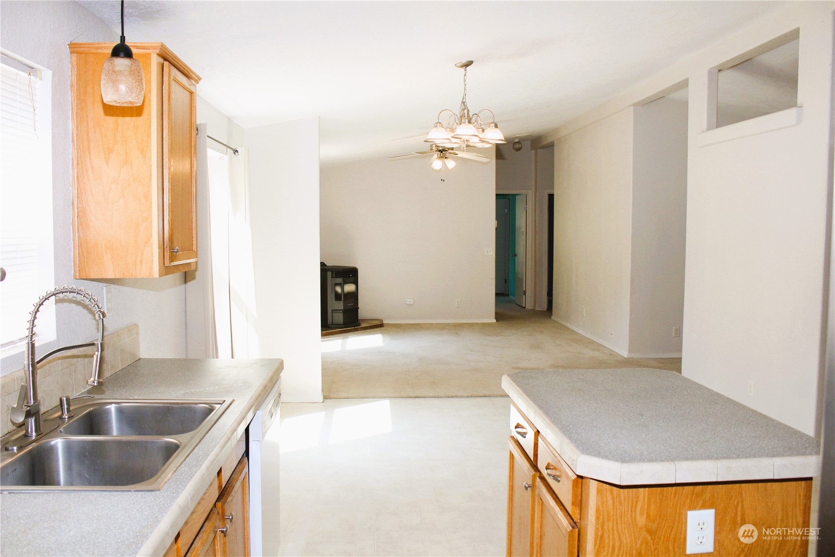 8145 183rd Avenue Southwest Rochester, WA 98579 - Photo 9 of 33 a kitchen with kitchen island a sink and a refrigerator