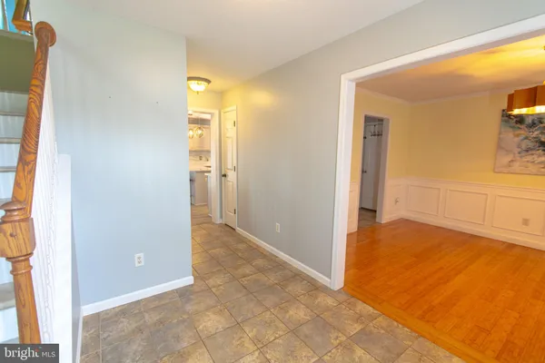 a an empty room with wooden floor and a fireplace