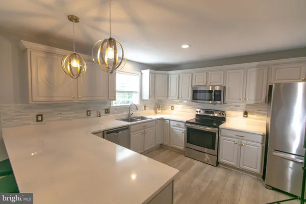 a kitchen with a sink stove and cabinets