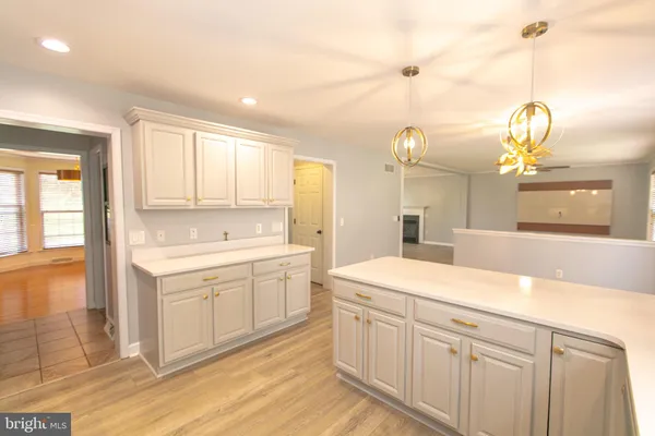 a bathroom with a sink a vanity a mirror and a bathtub