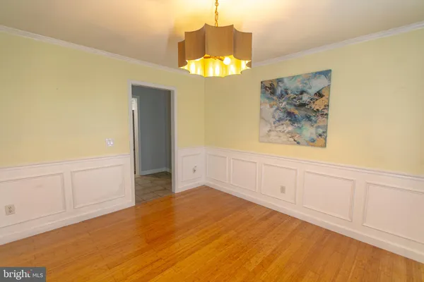 an empty room with a windows and chandelier