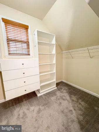 an empty room with a chandelier fan and a ceiling fan