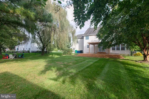 a view of house with outdoor space and garden