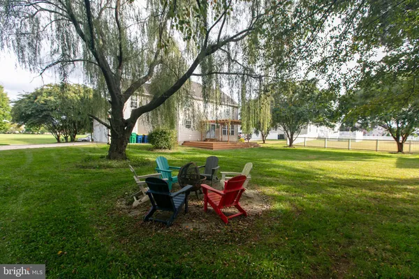 a view of a park with bench and trees