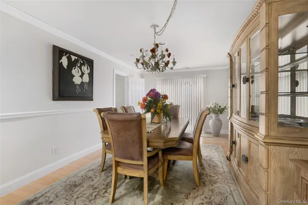 a view of a dining room with furniture and chandelier