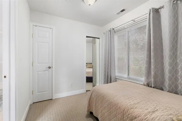 a bedroom with a bed and a shower