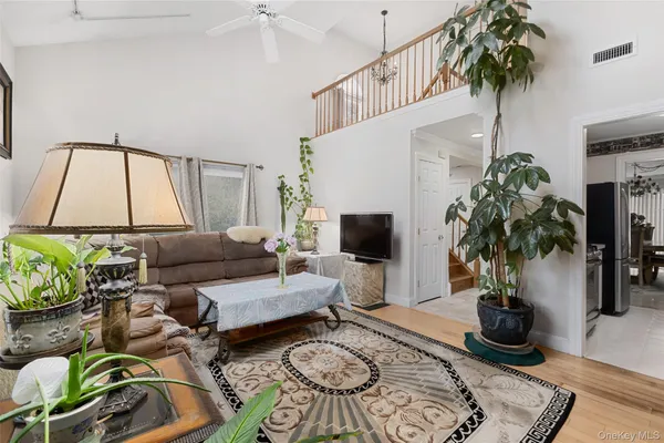a living room with furniture potted plant and a table