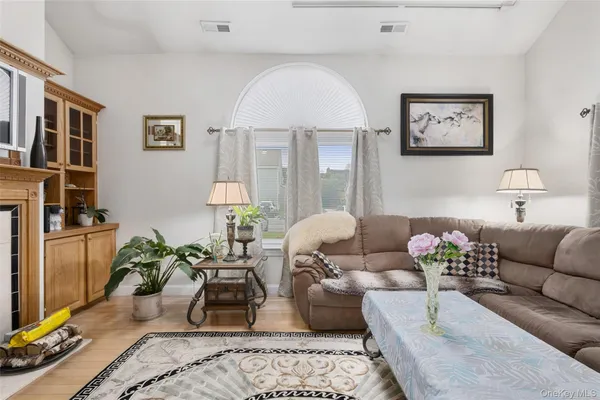 a living room with furniture flowerpot and a table