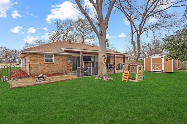 a front view of a house with a yard and sitting area