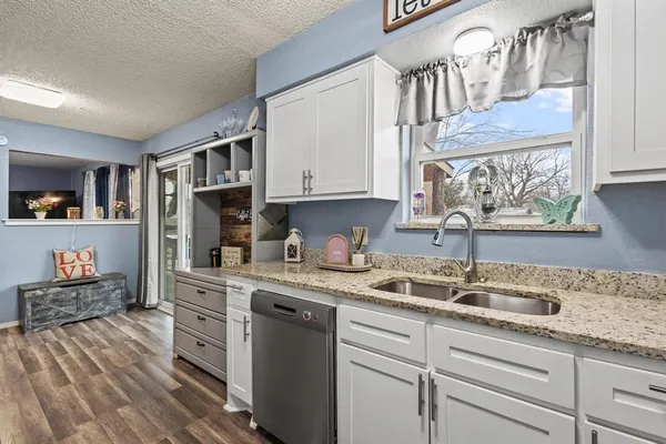 a kitchen with stainless steel appliances granite countertop a sink and cabinets