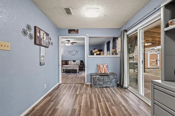 a room with lots of wooden furniture and large window