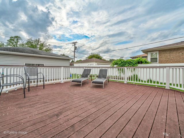 a view of a terrace with wooden floor and fence