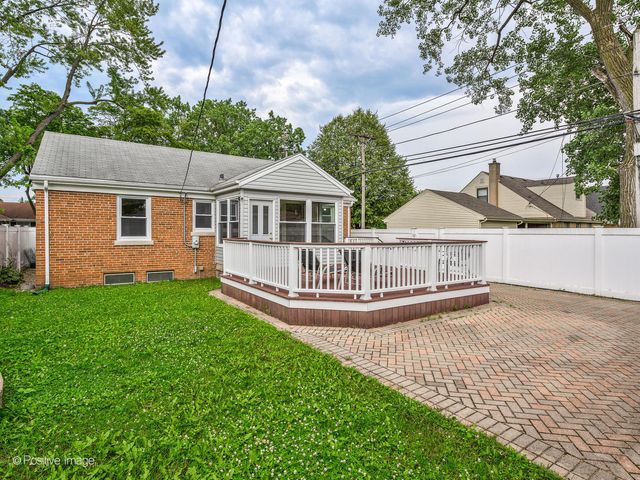 a view of a house with a yard and a porch