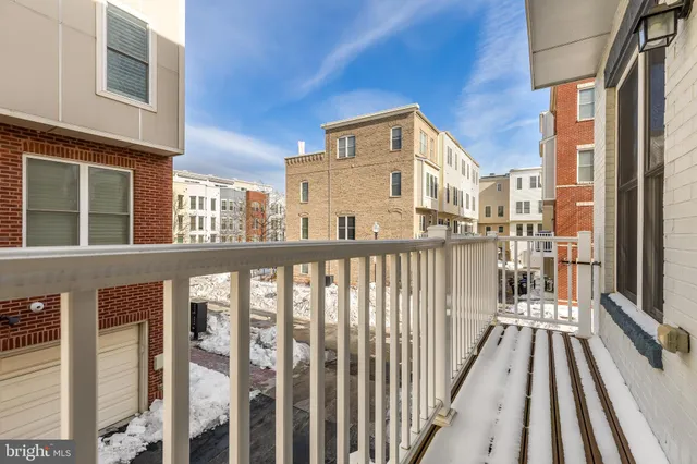 a living room with furniture large window and wooden floor