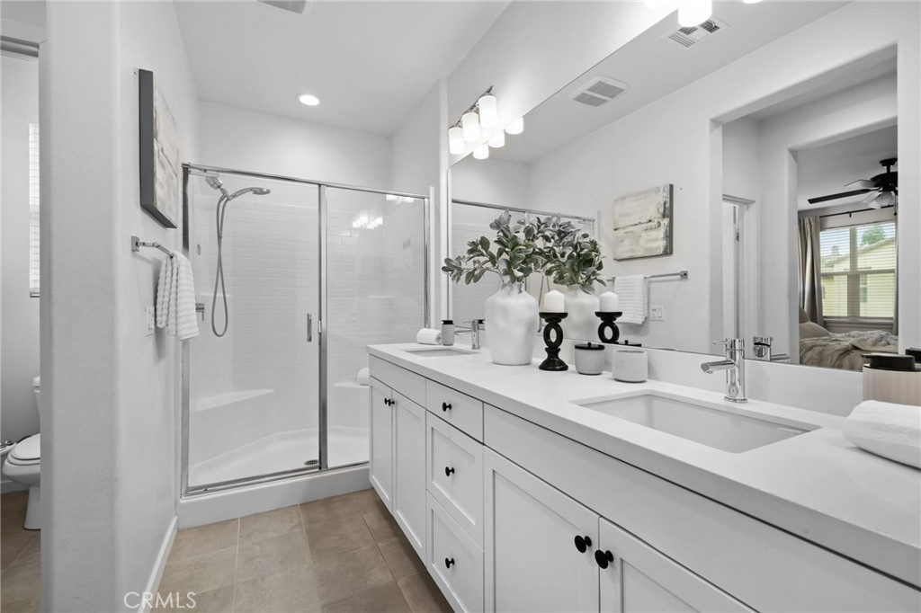 9463 Retreat Place Rancho Cucamonga, CA 91730 - Photo 18 of 37 a bathroom with a double vanity sink mirror and shower