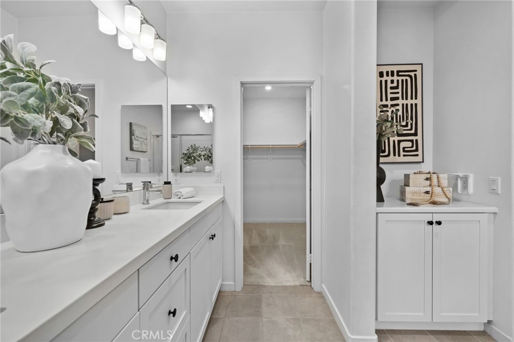 9463 Retreat Place Rancho Cucamonga, CA 91730 - Photo 19 of 37 a bathroom with a sink a light fixture and a mirror