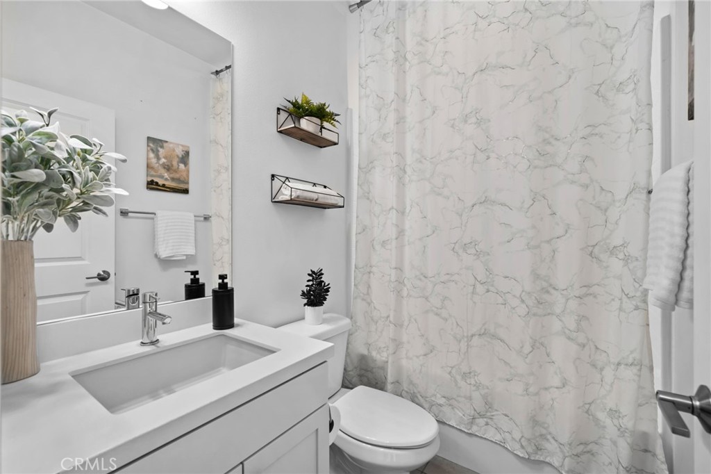 9463 Retreat Place Rancho Cucamonga, CA 91730 - Photo 24 of 37 a bathroom with a sink a toilet and shower