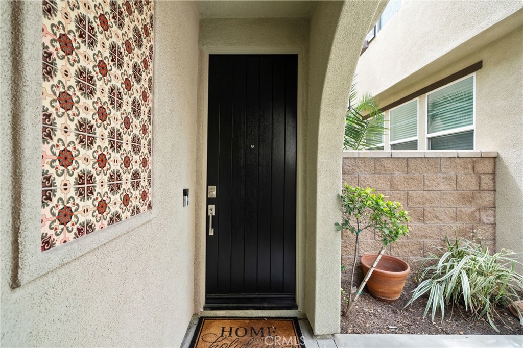 9463 Retreat Place Rancho Cucamonga, CA 91730 - Photo 5 of 37 front view of a house with a potted plant and a window