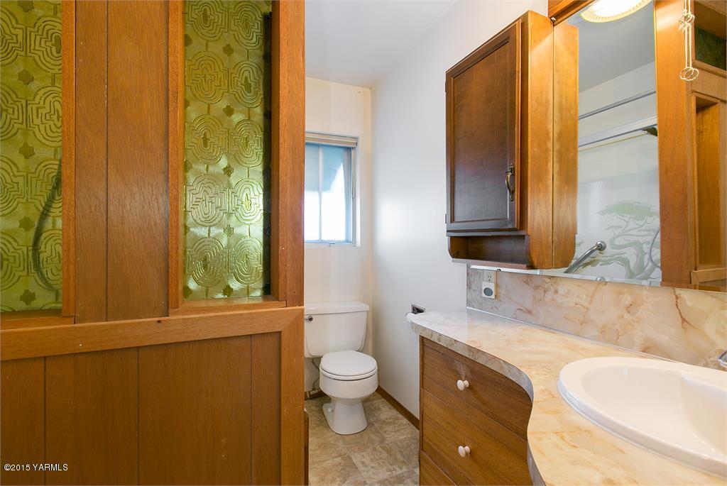 641 Lombard Loop Road Wapato, WA 98951 - Photo 17 of 18 a bathroom with a granite countertop sink toilet and shower