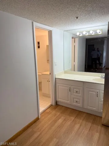 a bathroom with a granite countertop sink mirror and toilet