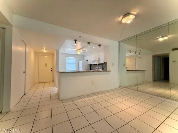 a view of a kitchen with kitchen appliances and cabinets