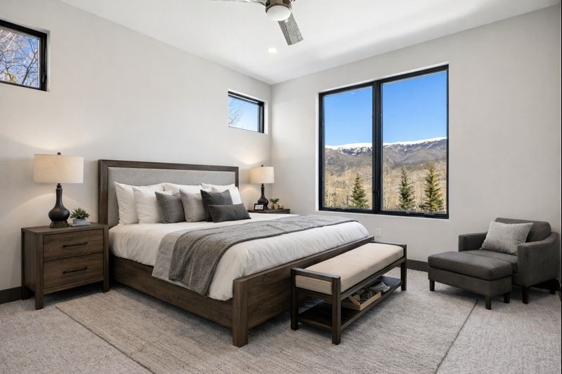 1325 Golden Eagle Road Silverthorne, CO 80498 - Photo 17 of 46 a spacious bedroom with a bed and glass window