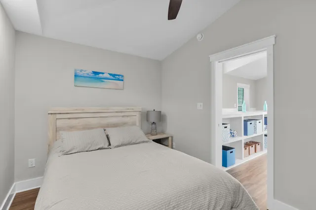 a bedroom with a bed and a painting on the wall