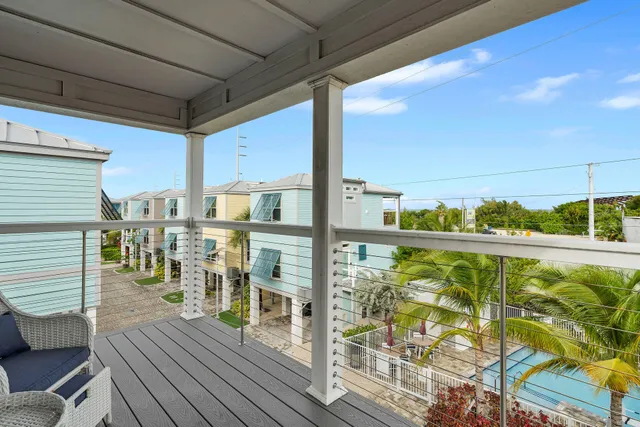 a view of a balcony with chairs