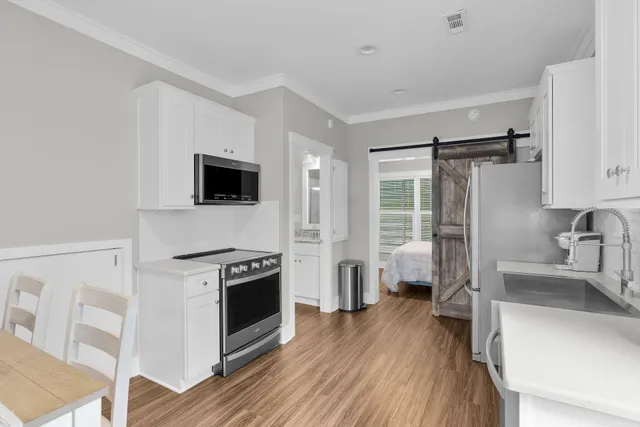 a kitchen with stainless steel appliances a stove a refrigerator and a sink