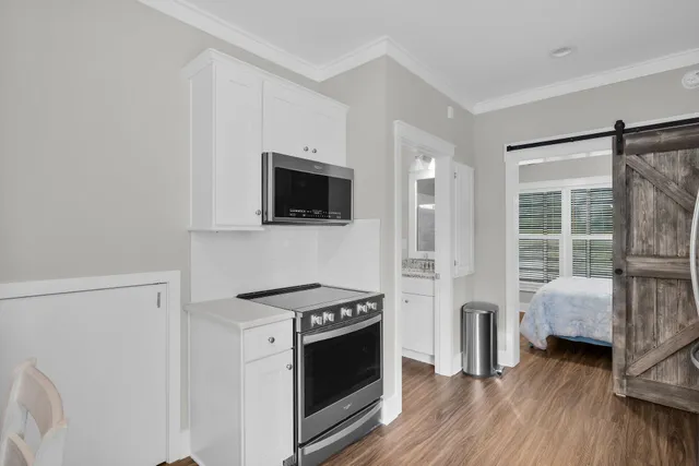 a view of kitchen with sink and refrigerator
